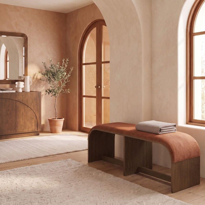 Velvet upholstered bench in warm brown with rounded seat corners in a living room