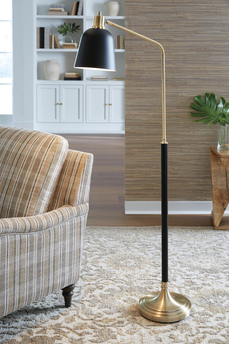 Metal floor lamp with black shade and brass-finish pole and round base