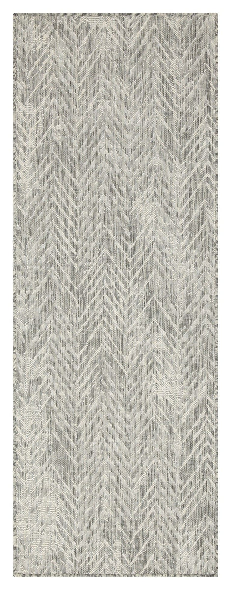 Indoor/outdoor area rug with light gray and cream chevron pattern, flatwoven look.