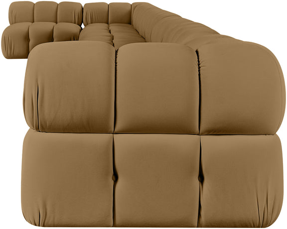 L-shaped velvet sectional sofa in tan with large tufted cushions and rounded arm sections