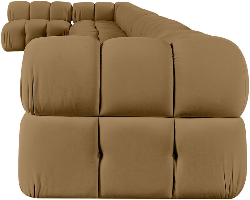 L-shaped velvet sectional sofa in tan with large tufted cushions and rounded arm sections