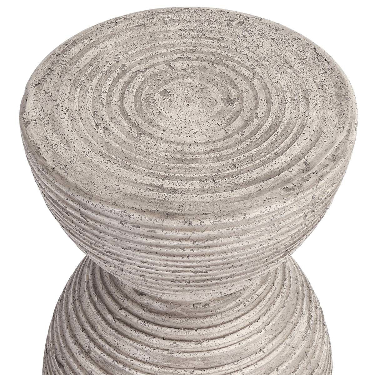 Light gray outdoor hourglass accent table with textured top and ribbed sides