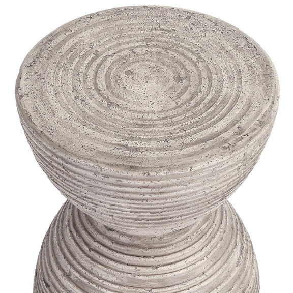 Light gray outdoor hourglass accent table with textured top and ribbed sides