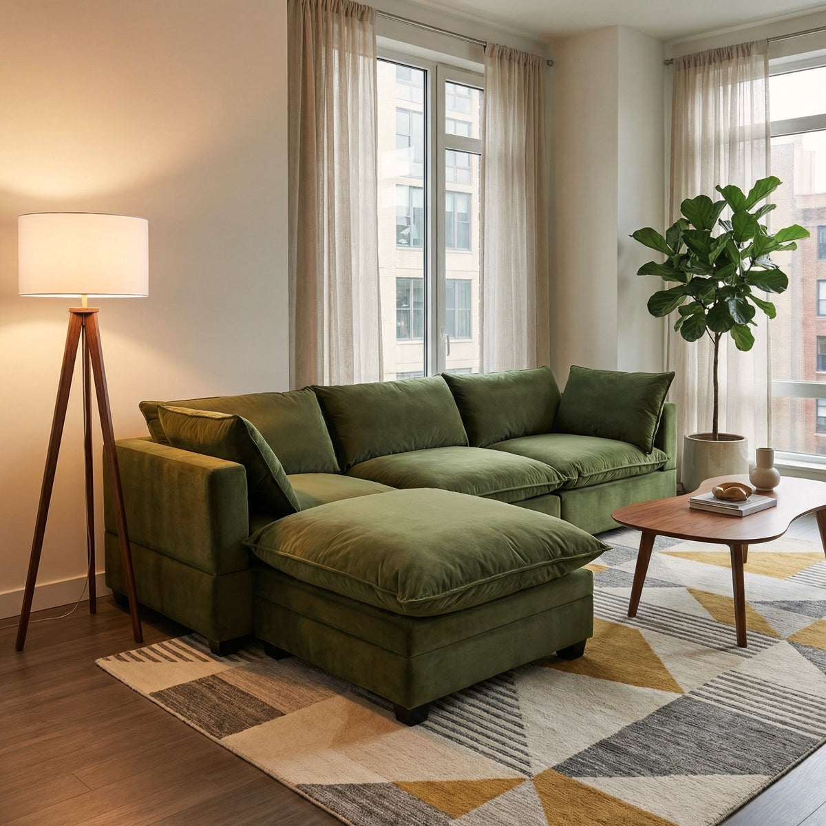 Olive green sectional sofa with chaise, tufted back cushions, and throw blanket