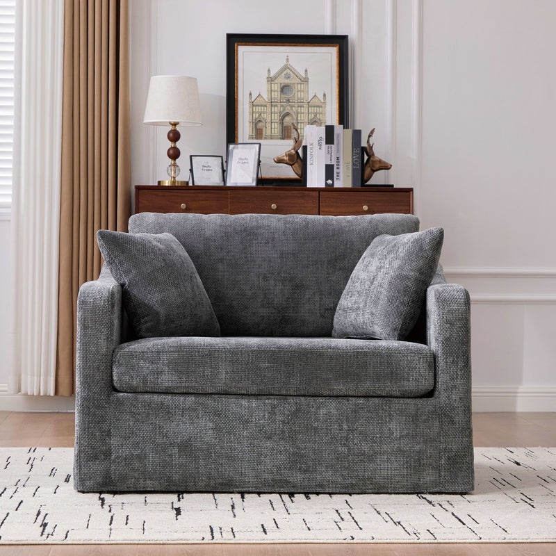 Dark gray fabric accent chair with 2 bolster pillows, square arms, boxy silhouette