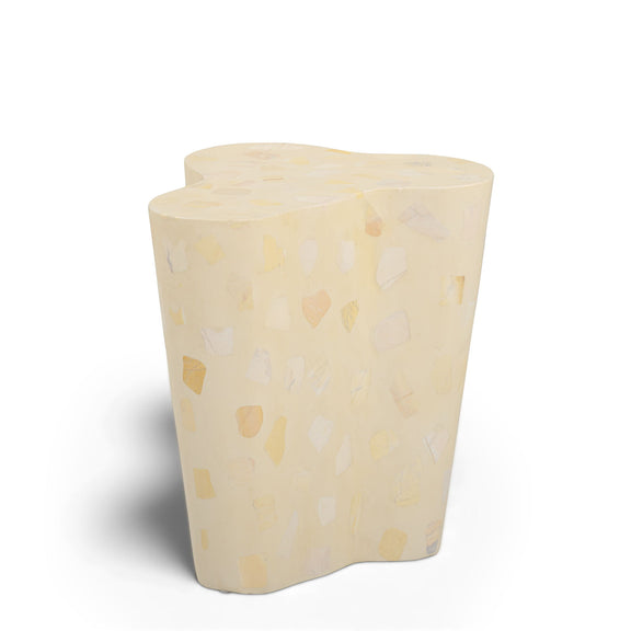 Beige terrazzo-pattern side table with curved sides and flat rounded top