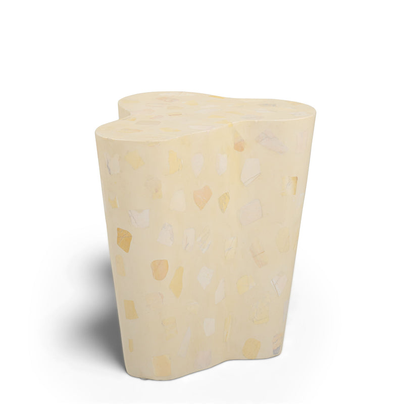 Beige terrazzo-pattern side table with curved sides and flat rounded top