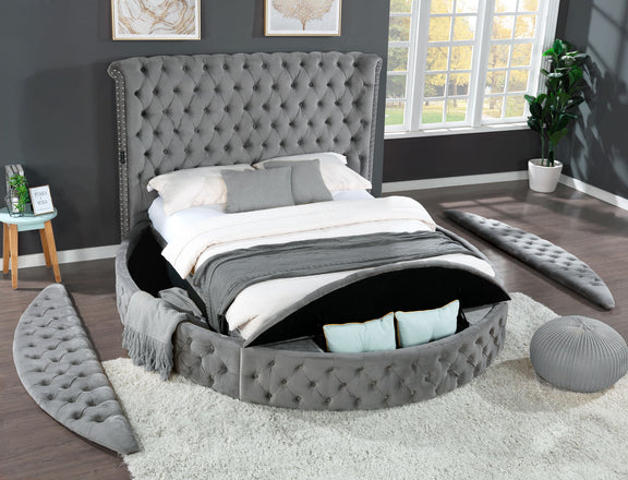 Gray tufted king bed with upholstered frame and storage drawer base