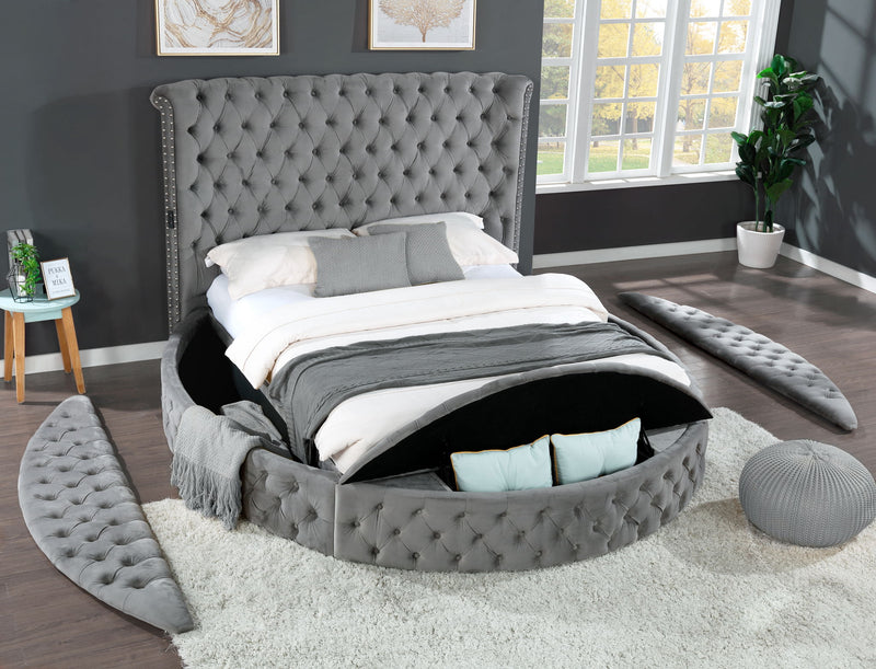 Gray tufted king bed with upholstered frame and storage drawer base