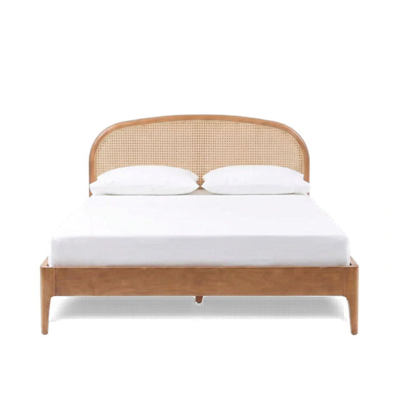 Light brown rattan bed with rounded woven headboard and white bedding