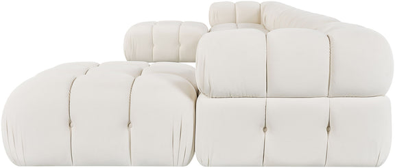 White modular sectional chair and ottoman with tufted cushions and rounded edges