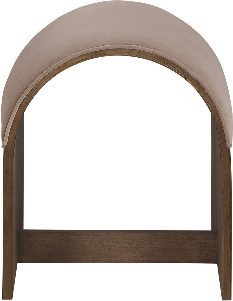 Close-up of beige velvet upholstered arched bench back with dark wood frame