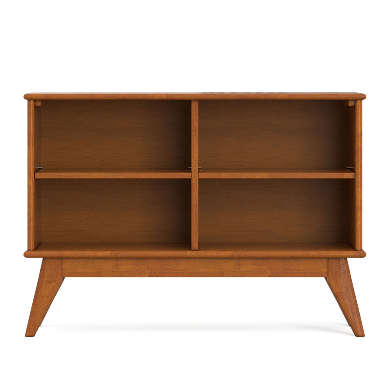 Light brown low bookcase with four open storage sections behind the central divider.