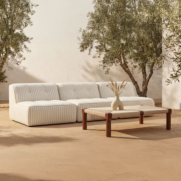 Outdoor coffee table with dark brown wooden legs and beige fabric tabletop