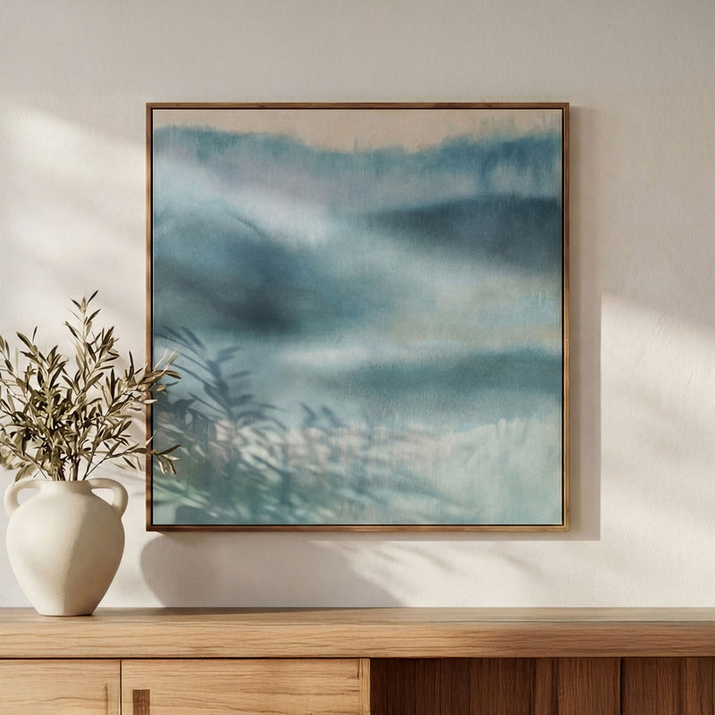 Wood-framed abstract blue landscape painting with soft cloudlike brushstrokes