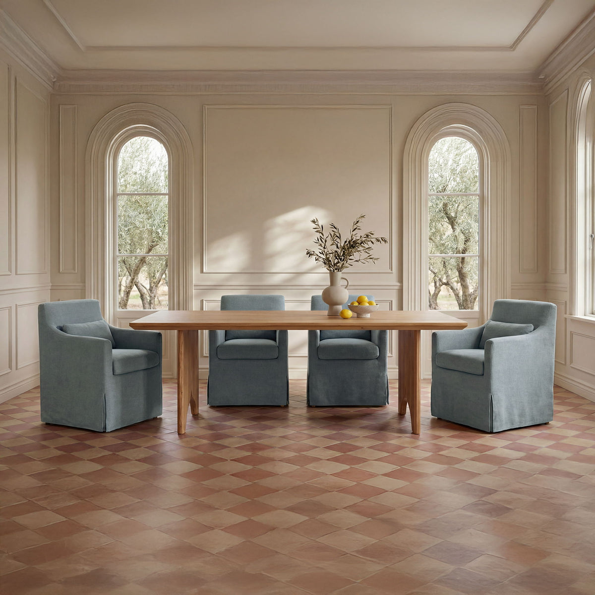 Natural wood dining table with four upholstered chairs in a light room setting