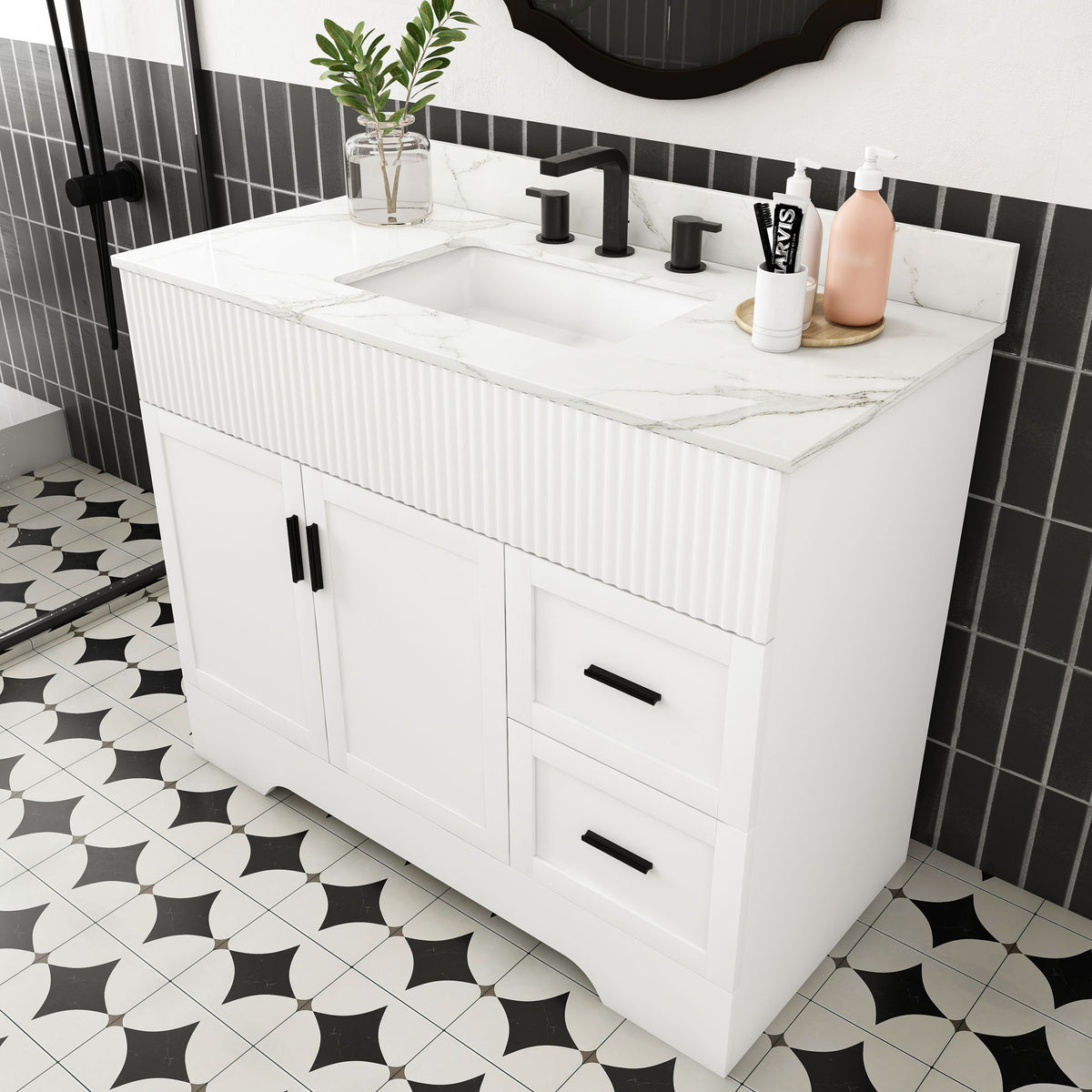 White bathroom vanity with fluted front, single sink, two doors and two drawers.