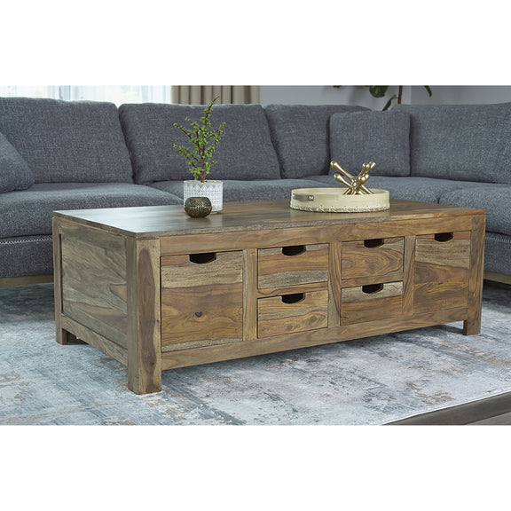 Natural wood coffee table with multiple front drawers and black pull handles