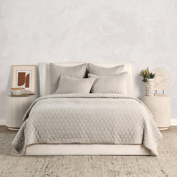 Natural-toned quilt set with diamond quilting and four matching pillows
