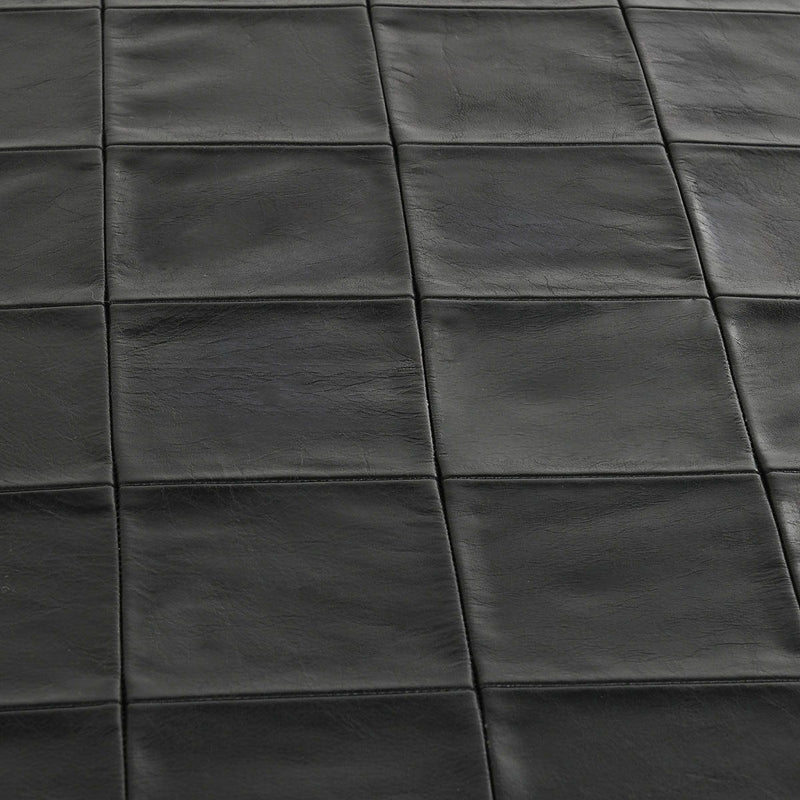Close-up of dark leather bench seat with square stitched panels