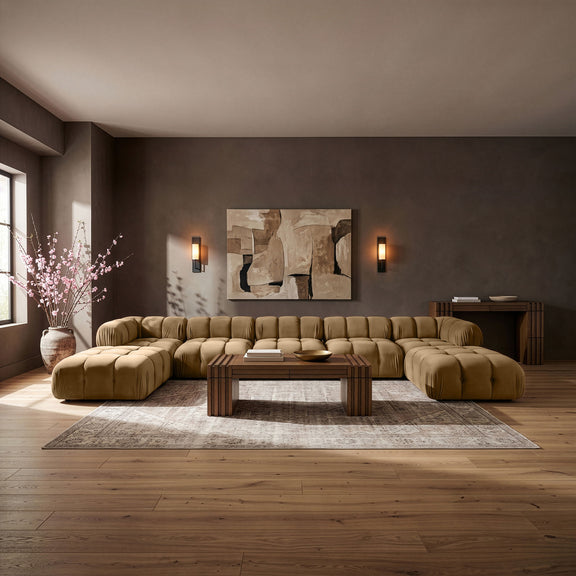 Beige modular sectional sofa with tufted cushions and rounded armrests, curved seating