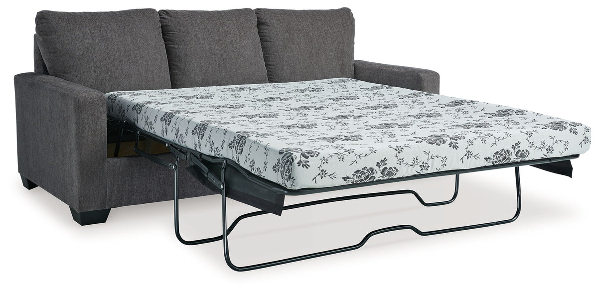 Dark gray sofa with pull-out bed frame and floral patterned mattress cover