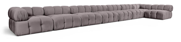 L-shaped velvet sectional sofa in dark gray with tufted seat cushions and rolled arms