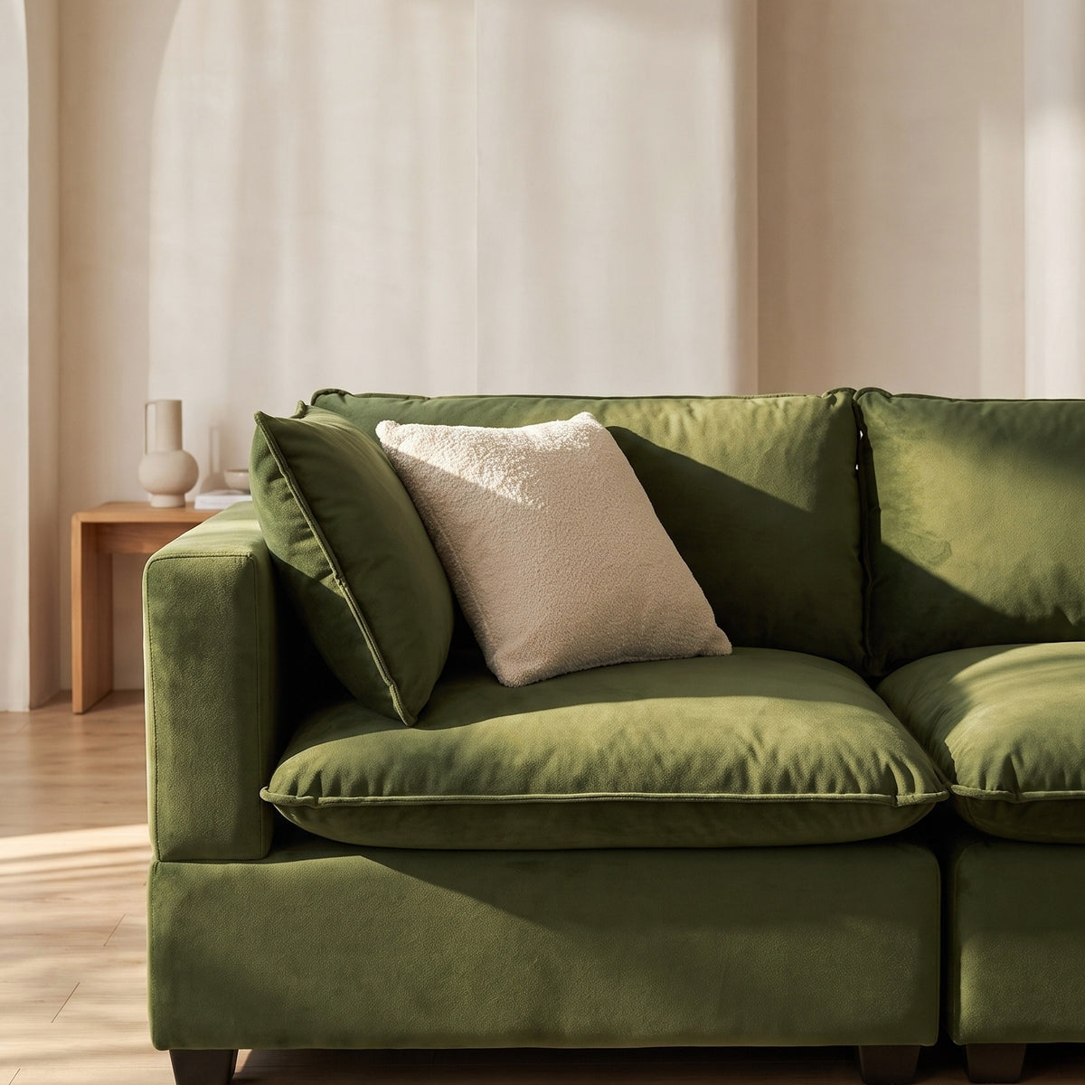 Olive green sectional sofa chaise with beige and green accent pillows
