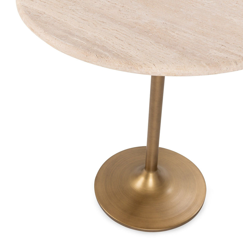 Close view of round travertine top and gold pedestal table base.