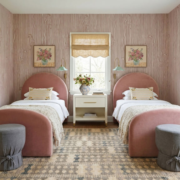 Cream nightstand with drawer between twin beds in a bedroom, shown from the front.