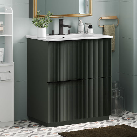 Dark green fluted bathroom vanity with white ceramic sink and center handle bar