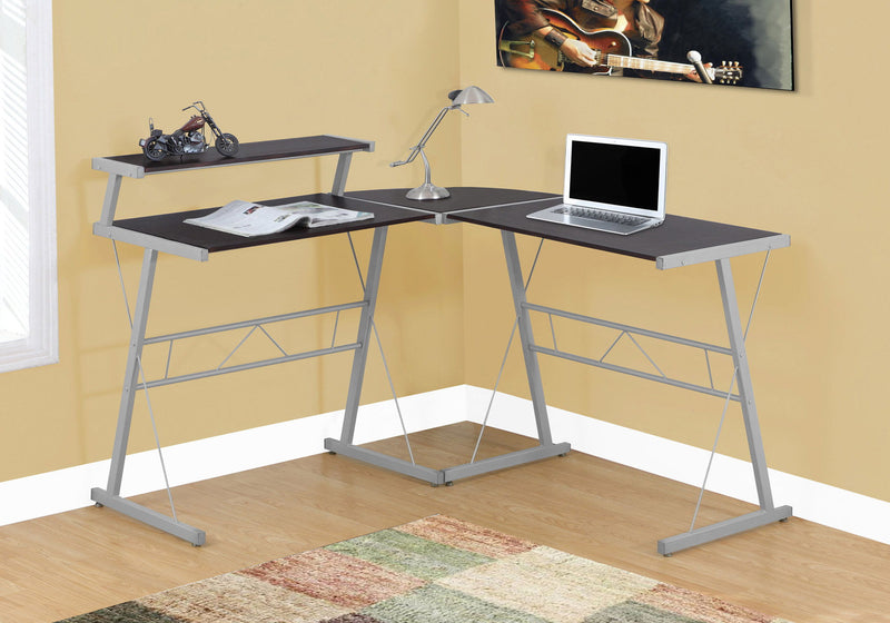 Corner L-shape computer desk with dark brown tops, gray metal legs, laptop-ready work area