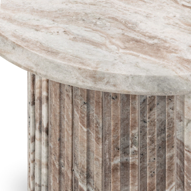 Marble tabletop edge with light cream surface and gray veining over striped base