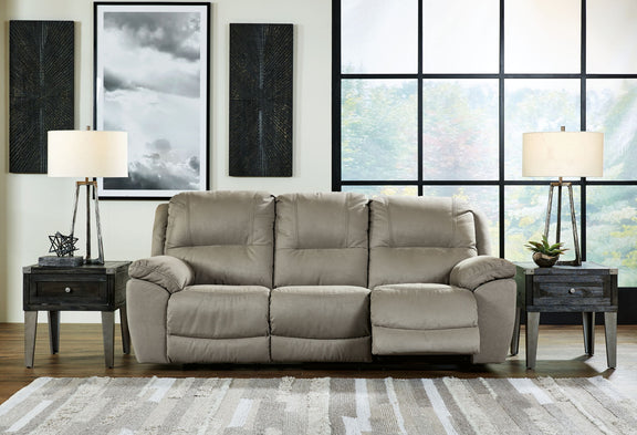 Putty reclining loveseat with tufted back, wide armrests, and drop-down footrest