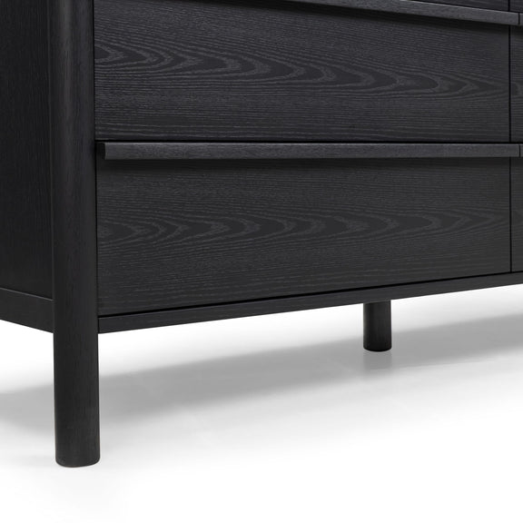 Black wood dresser showing two drawer fronts with subtle wood-grain pattern