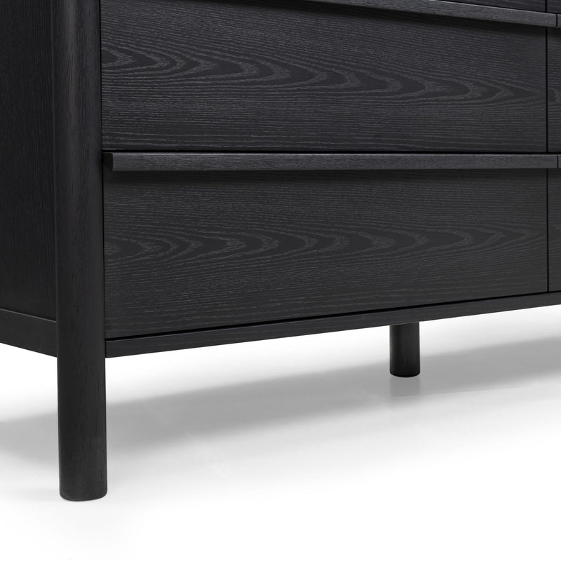 Black wood dresser showing two drawer fronts with subtle wood-grain pattern