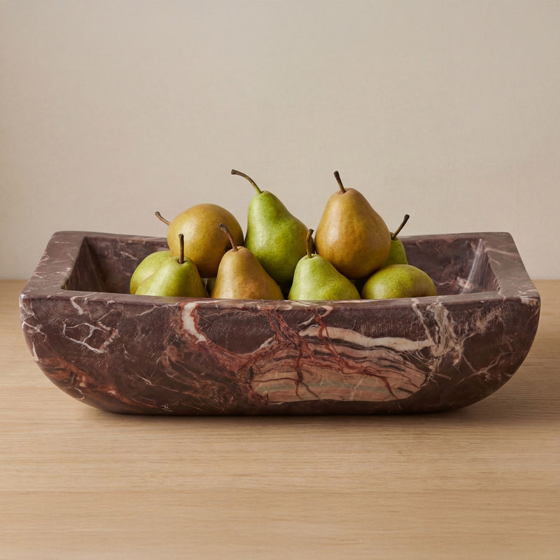 Red-brown marble basin with flared rim, filled with pears and green fruit