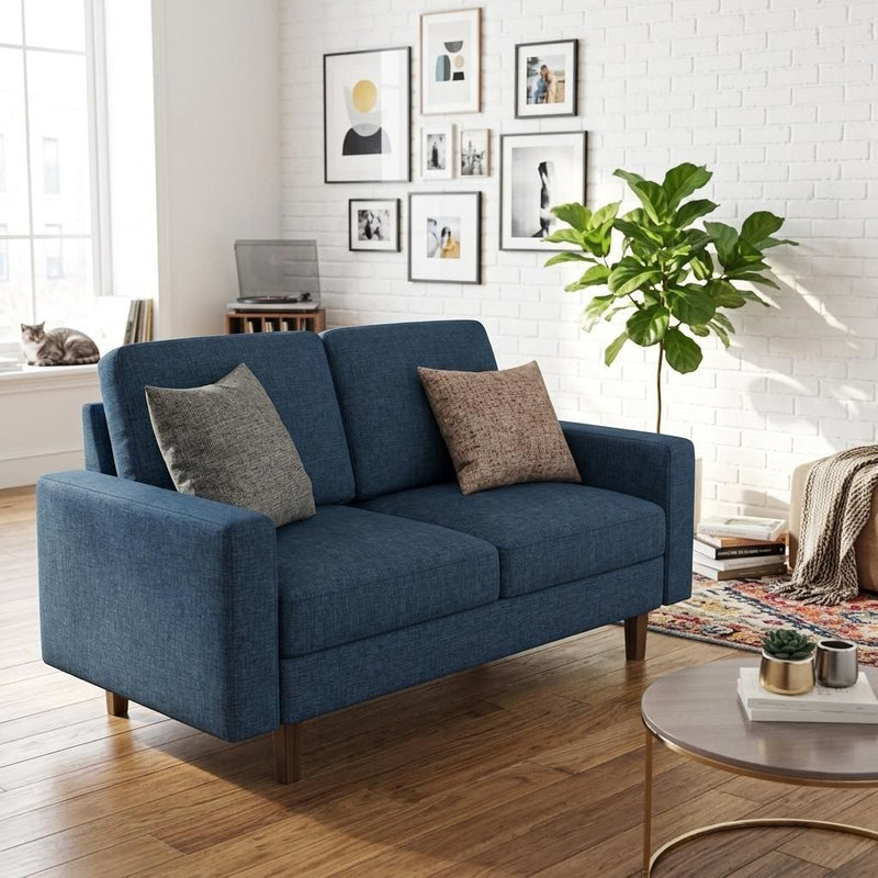Blue loveseat with two seat cushions, two back cushions, and decorative throw pillows