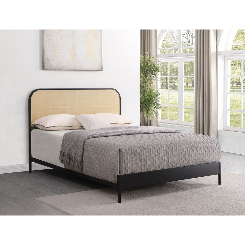 Black bed with tan arched headboard, fabric panel, and slatted base.