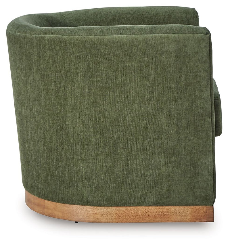 Forest green swivel chair side view with padded backrest and light wood rocker base