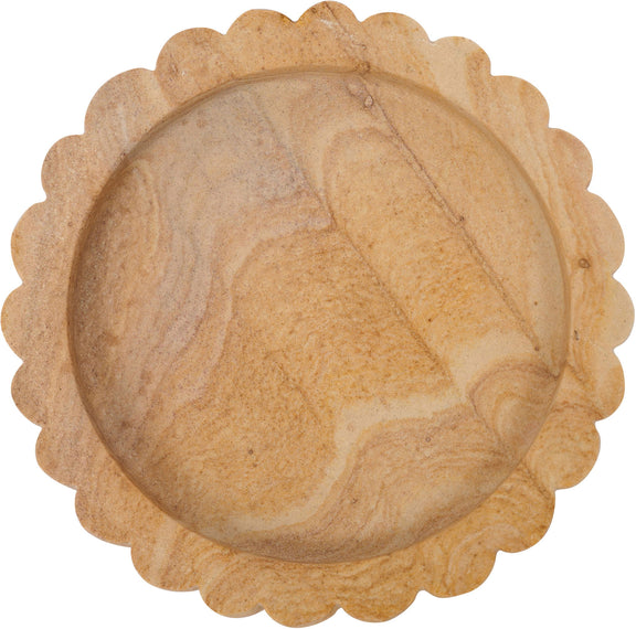 Round sandstone tray with scalloped rim and textured sand-colored surface, top view
