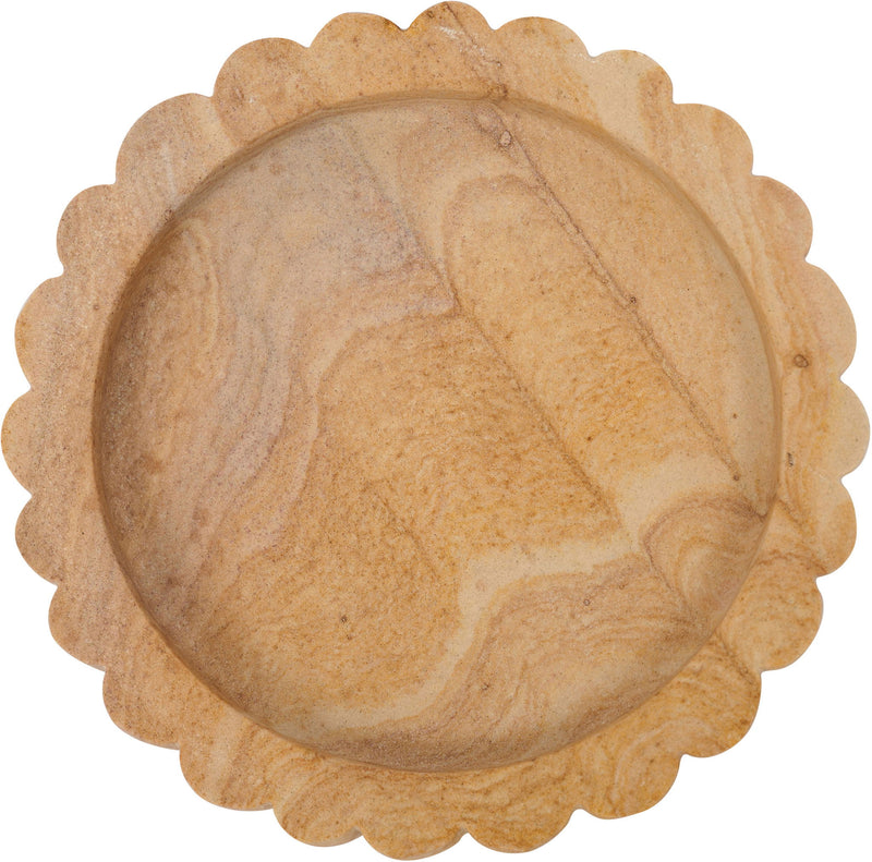 Round sandstone tray with scalloped rim and textured sand-colored surface, top view