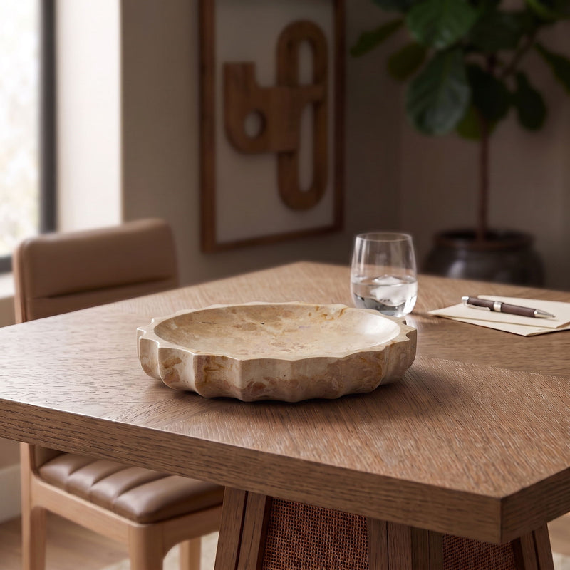 Beige genuine marble bowl on a tabletop, featuring natural stone texture