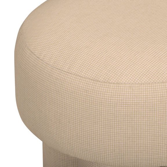 Beige textured upholstered accent stool with rounded seat and curved side.