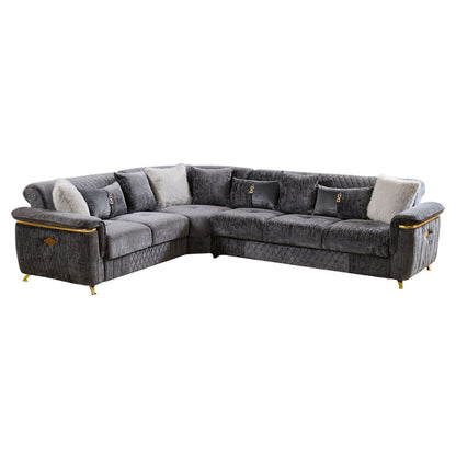 Reversible sectional sofa in dark gray with patterned accent pillows and gold-trimmed arms
