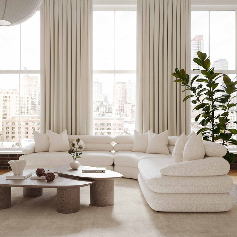 Washed ash oblong coffee table with rounded tabletop, shown in front of a sofa