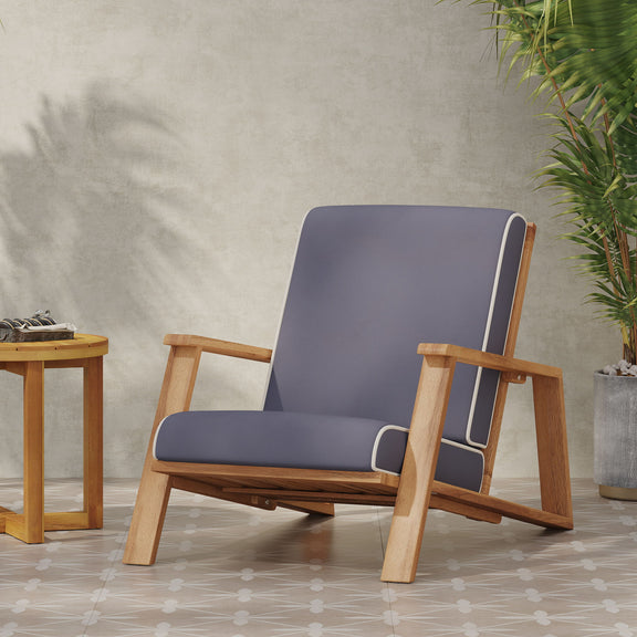 Dark gray padded outdoor lounge chair with light wood frame and angled armrests