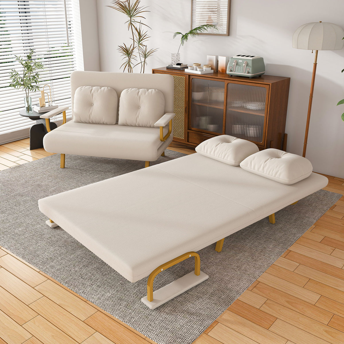 Convertible sofa bed, white fabric with tufted backrest and extended bed cushion.