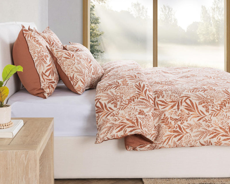 Chestnut orange leaf-pattern duvet with matching pillows in a bed scene