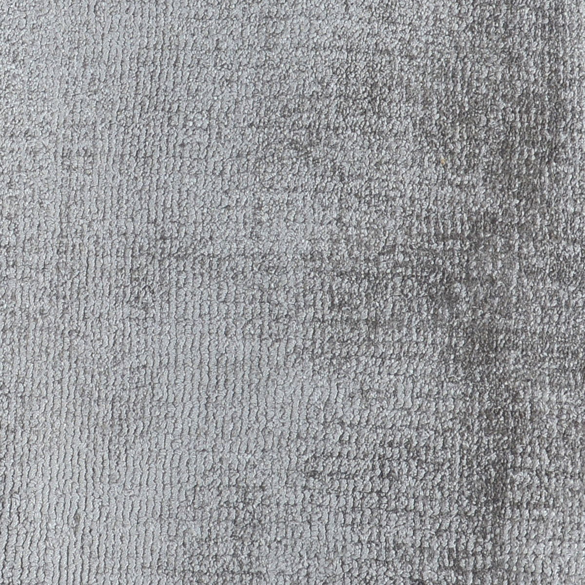 Light gray distressed area rug with tight textured pattern and even flat pile.